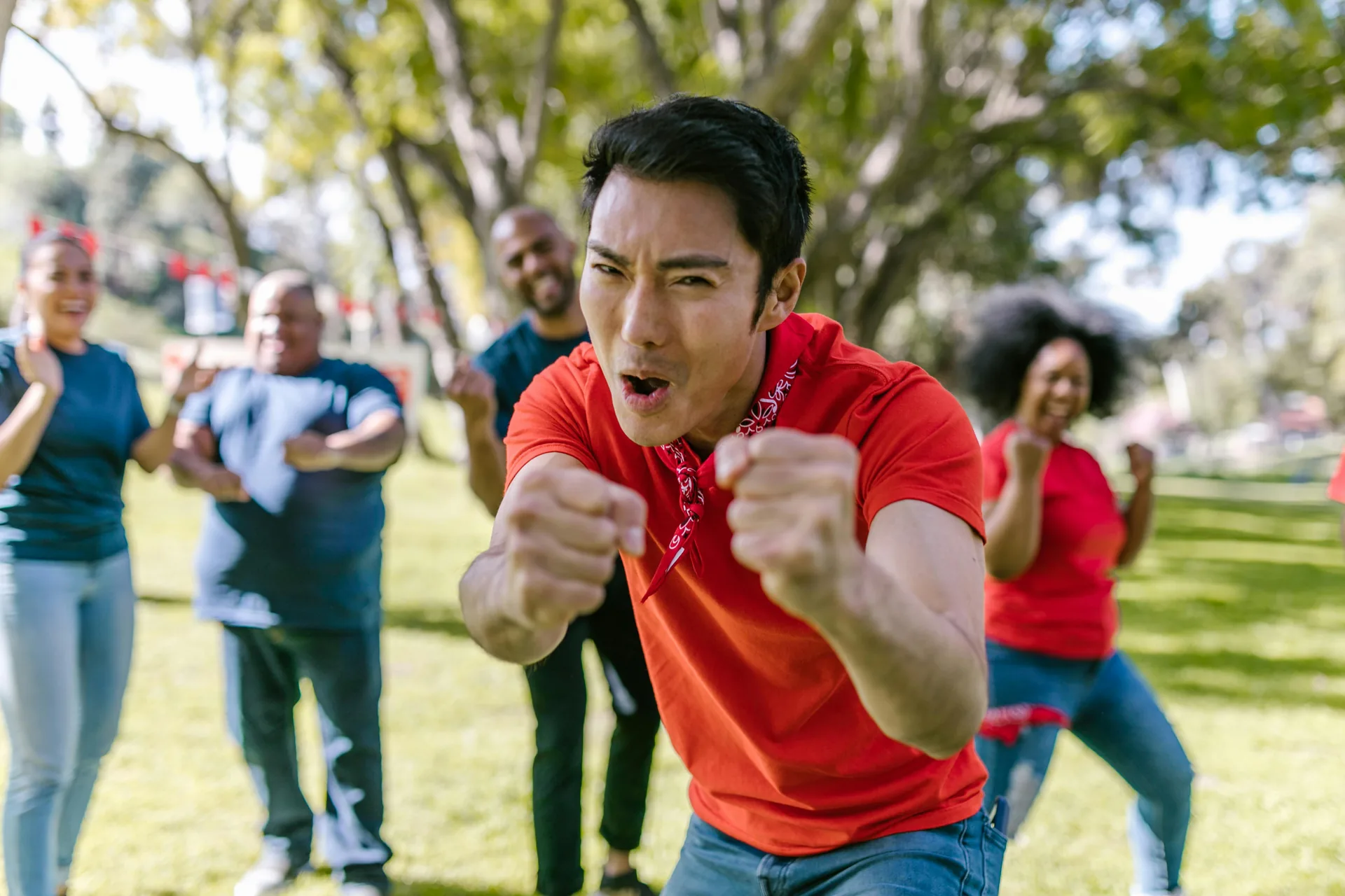 A group of people playing a team game in a park